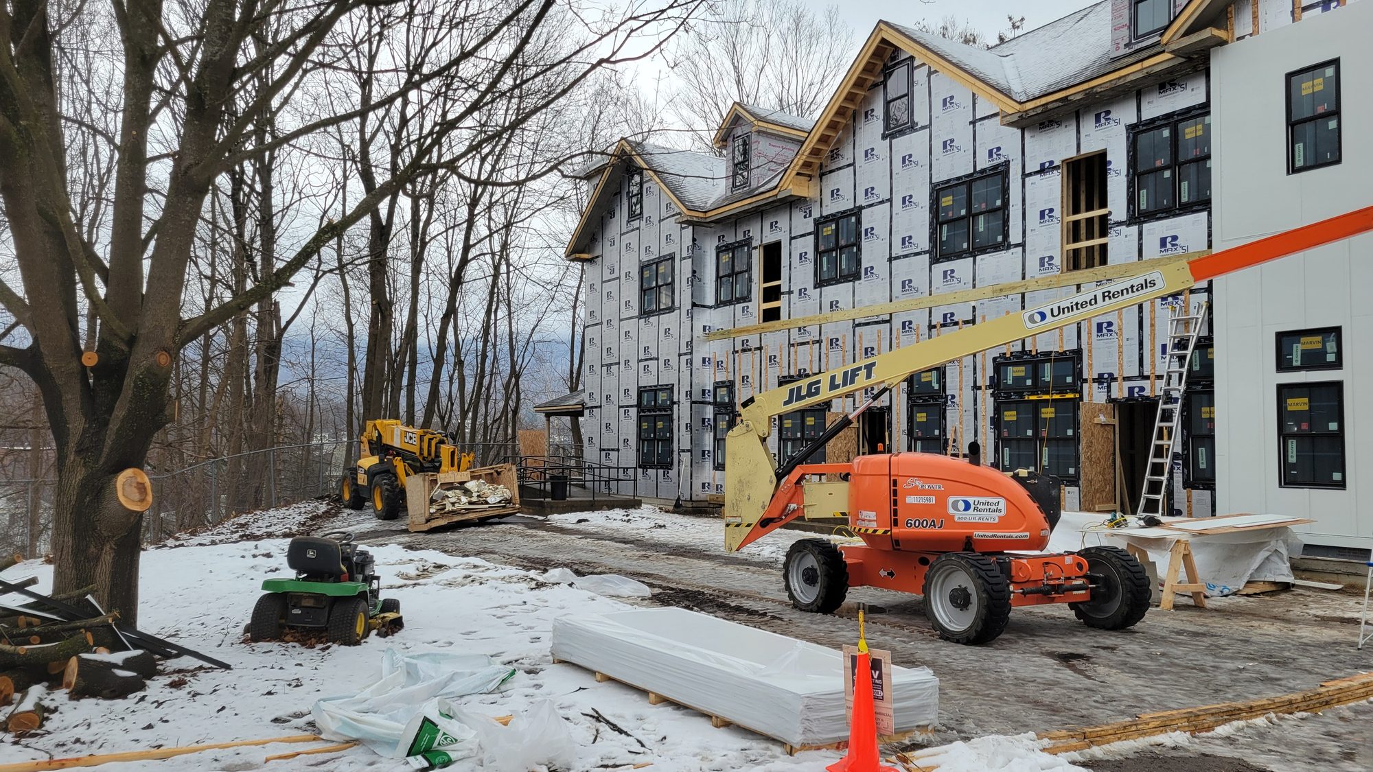 Housewrap and new framing going on the building in snow